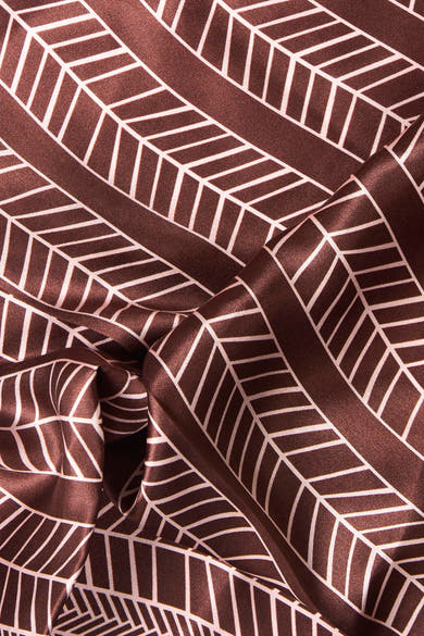 Multicolored geometric patterned foulard in rich brown with white lines, soft satin texture, close-up view
