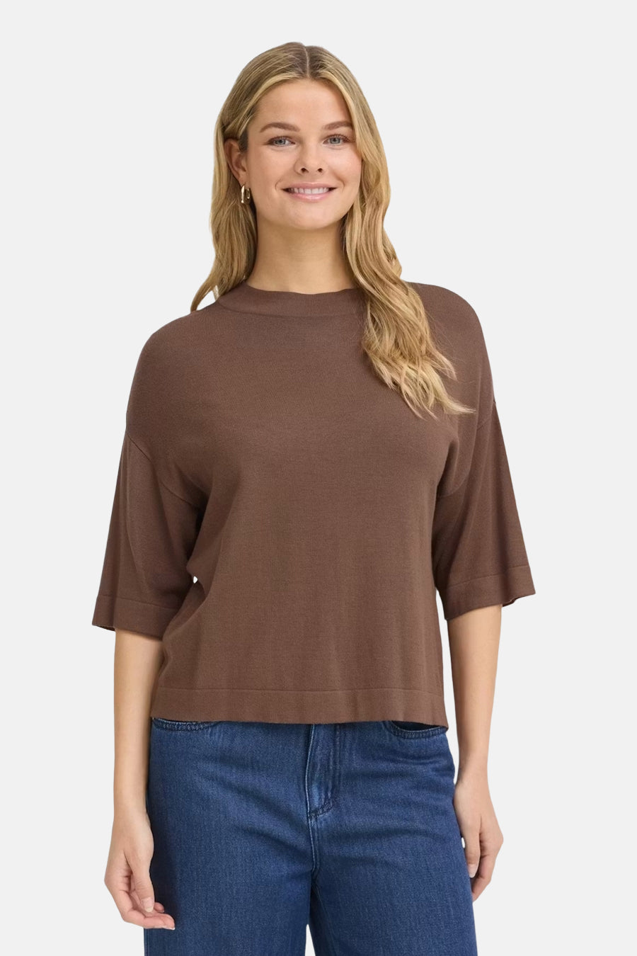 Brown O-neck sweater with three-quarter sleeves and ribbed hem, worn with blue jeans, front view