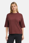 Burgundy round-neck sweater by Fransa® with ribbed trim, three-quarter sleeves, and relaxed fit, worn with black trousers in front view.