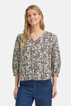 Multicolored short-sleeve blouse with floral pattern and V-neck, worn with blue jeans, front view