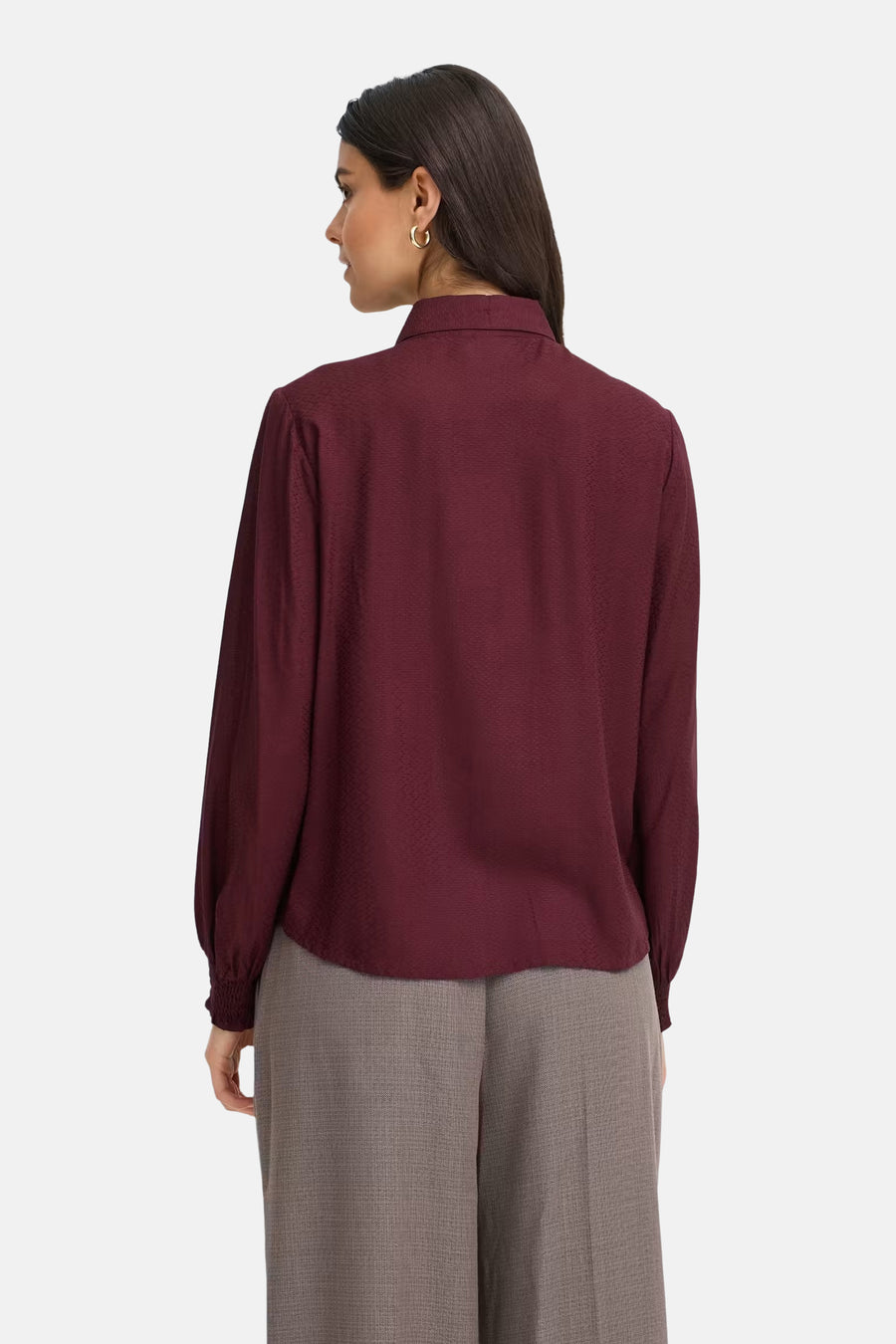 Bordeaux long-sleeve blouse with textured fabric, shown from back on model wearing gray trousers