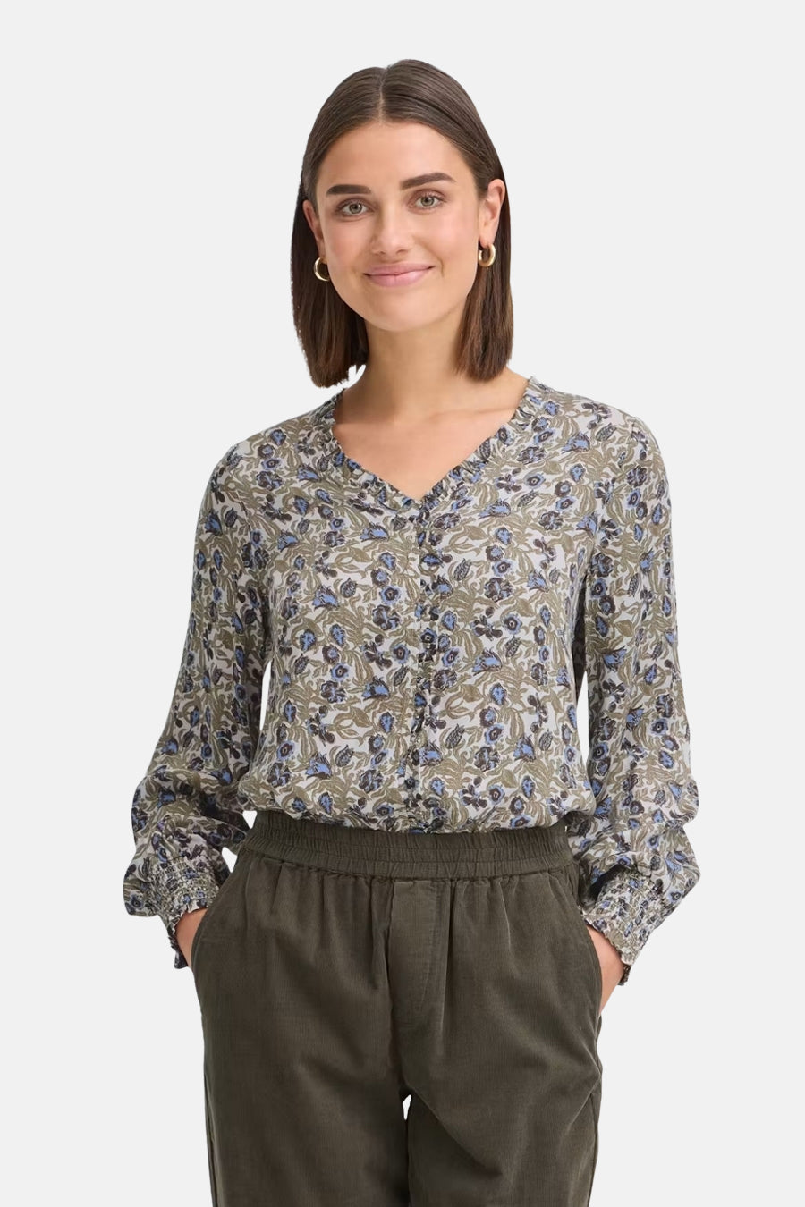 Multicolored long-sleeve blouse with floral pattern and V-neck, worn with olive green pants, front view