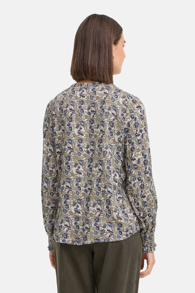 Multicolored long-sleeve blouse with floral pattern, back view, ruched cuffs, worn with olive corduroy pants