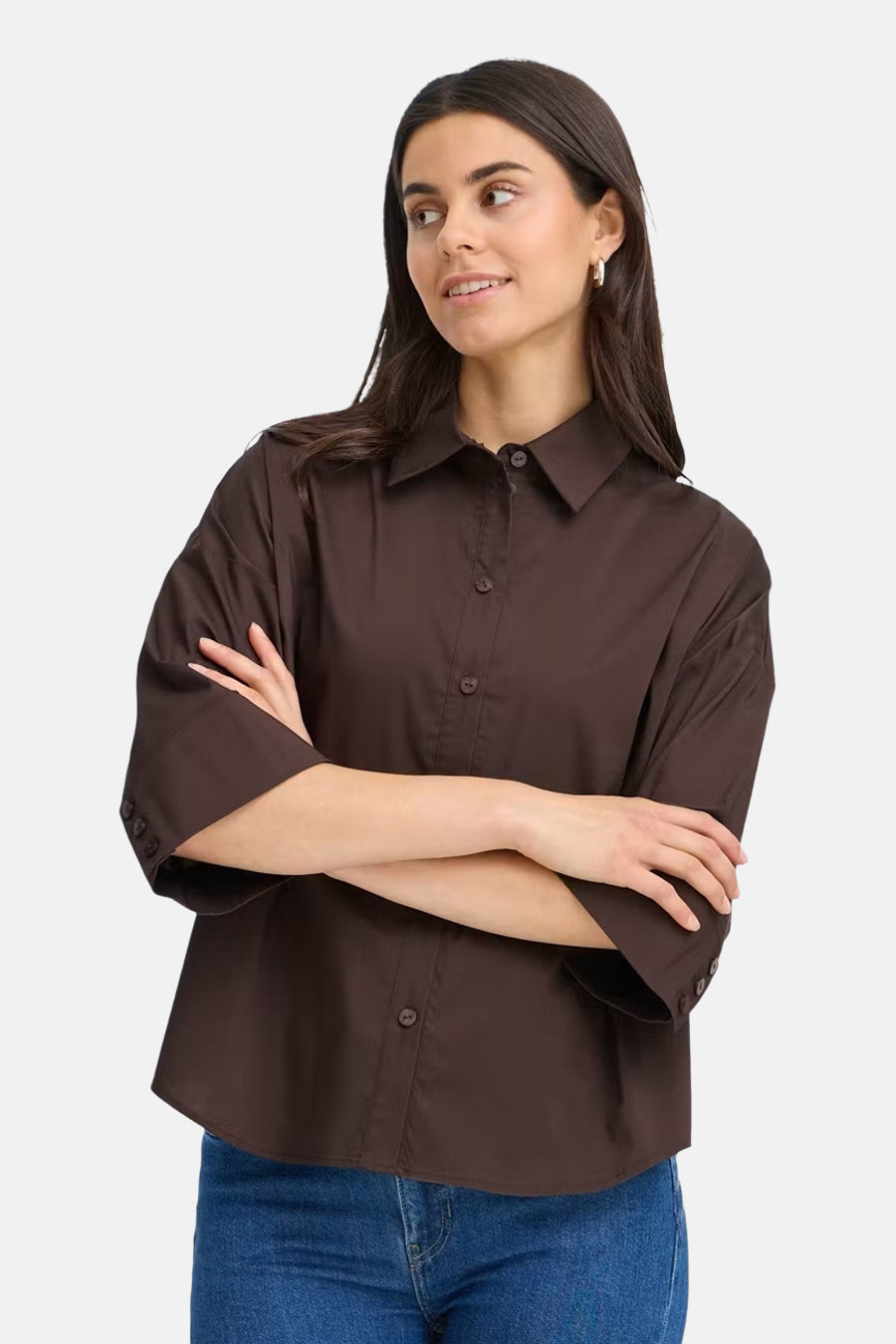 Brown long-sleeve shirt with button-down front and pointed collar, worn by model in lifestyle pose, paired with blue jeans