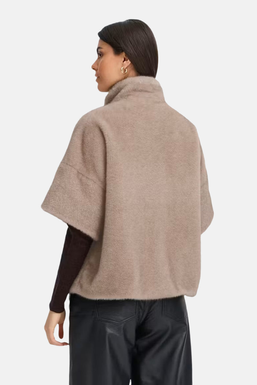 Beige fuzzy short coat with high collar, side view, worn over dark top and black leather pants