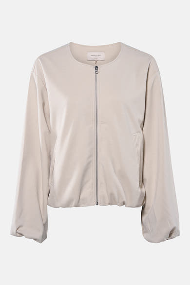 Veste courte beige de FREE/QUENT, avec une fermeture éclair argentée sur le devant et des poches discrètes.