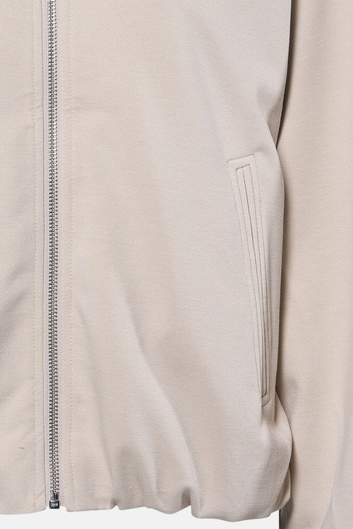 Veste courte beige de FREEQUENT, avec fermeture éclair argentée et poche passepoilée discrète.