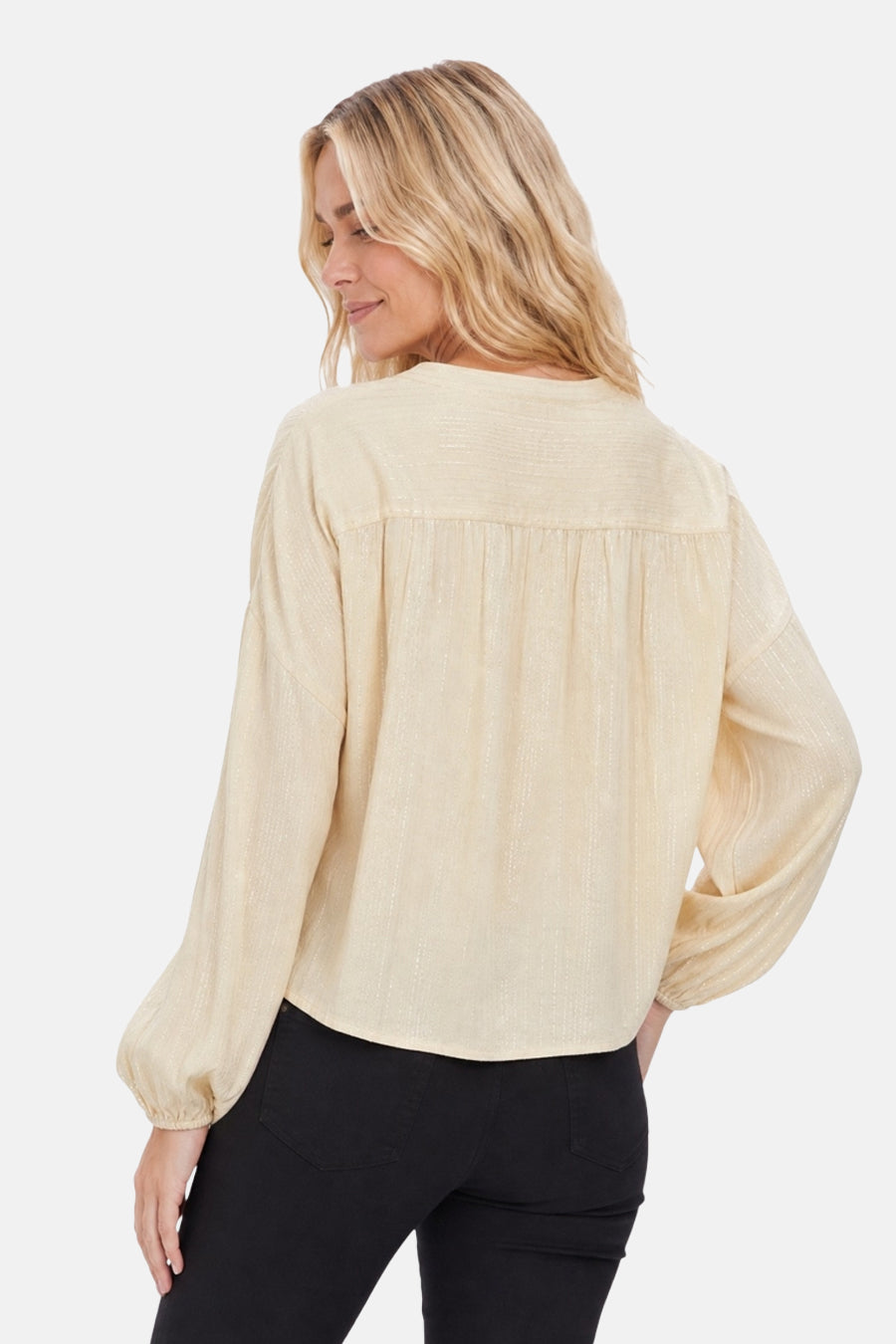 Yellow long-sleeve blouse with textured fabric and gathered back detail, shown from rear view on model wearing black pants