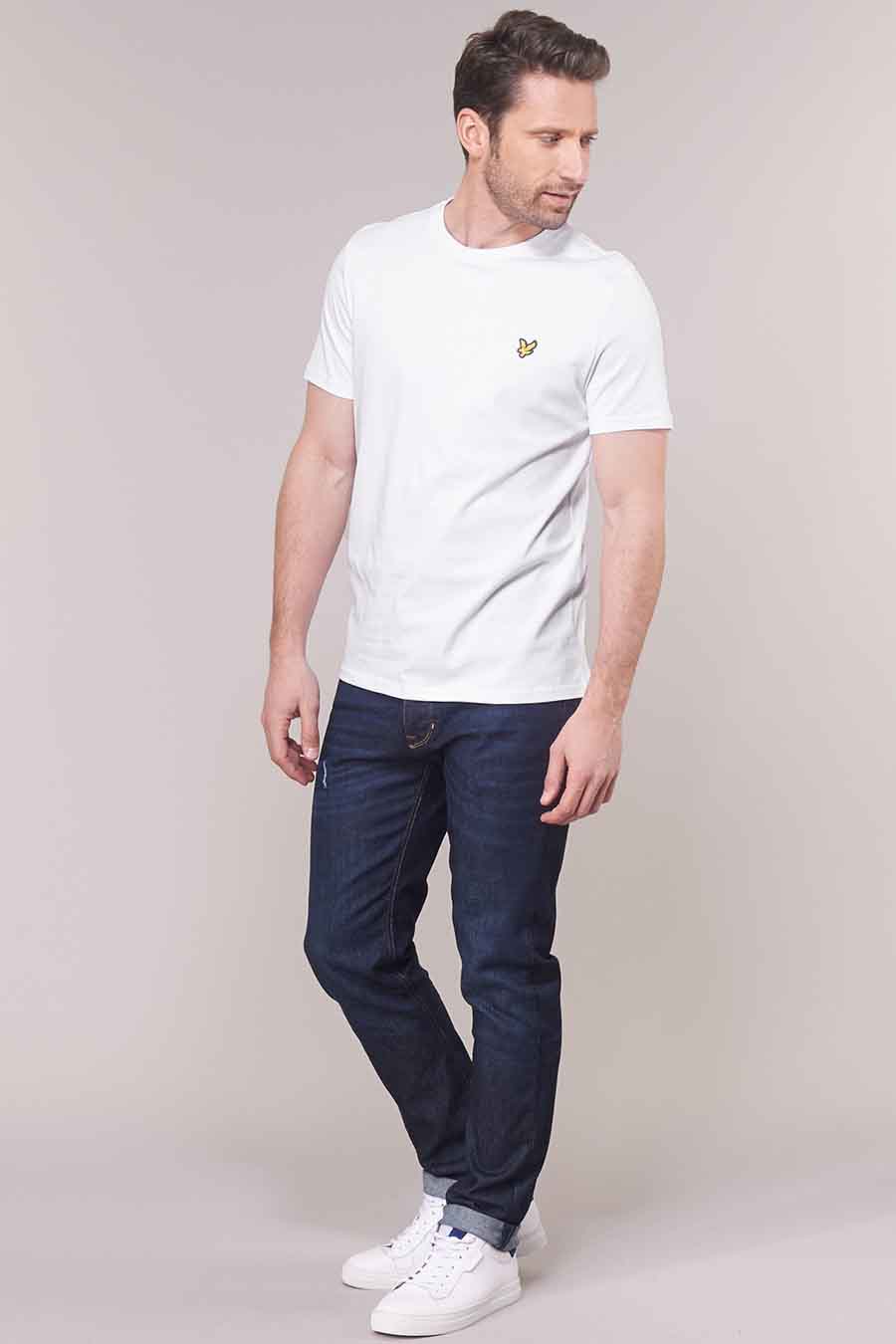 T-shirt blanc de LYLE & SCOTT, porté avec un jean bleu foncé et des baskets blanches.