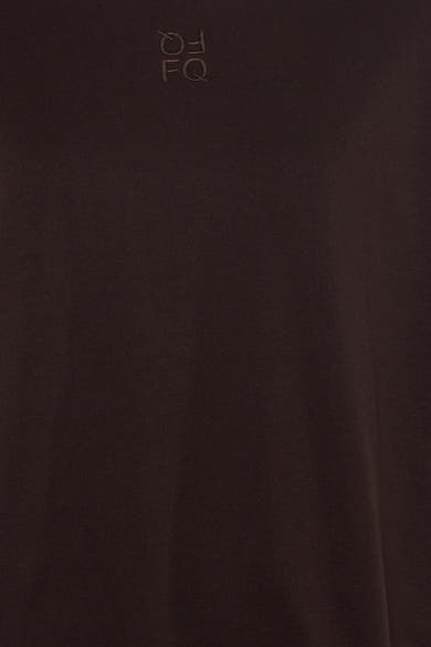 Brown short-sleeve t-shirt by FQ with subtle embroidered logo on chest, close-up view