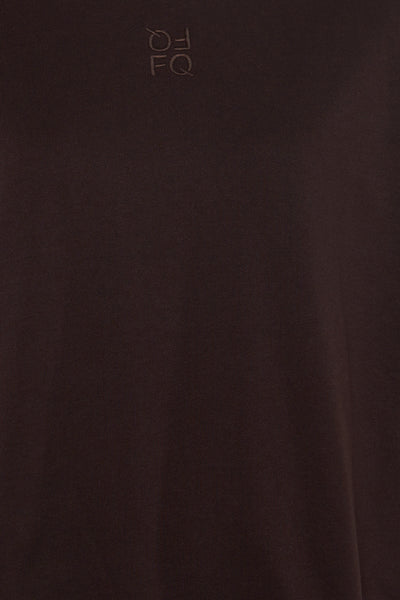 Brown short-sleeve t-shirt by FQ with subtle embroidered logo on chest, close-up view
