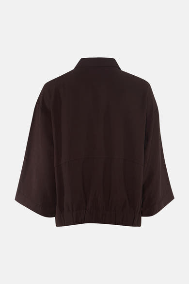 Brown long-sleeve blouse with relaxed fit and gathered hem, back view, smooth fabric texture