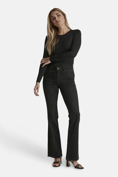 Black flared denim jeans by JADE, full-length front view, worn with black long-sleeve top and strappy heels