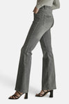 Light grey flared denim jeans by JADE, side view showing slim fit to wide leg, worn with olive top and black strappy heels