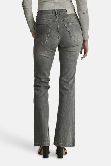 Light grey flared jeans by JADE, back view showing classic stitching, two rear pockets, and a straight-to-flare leg silhouette.
