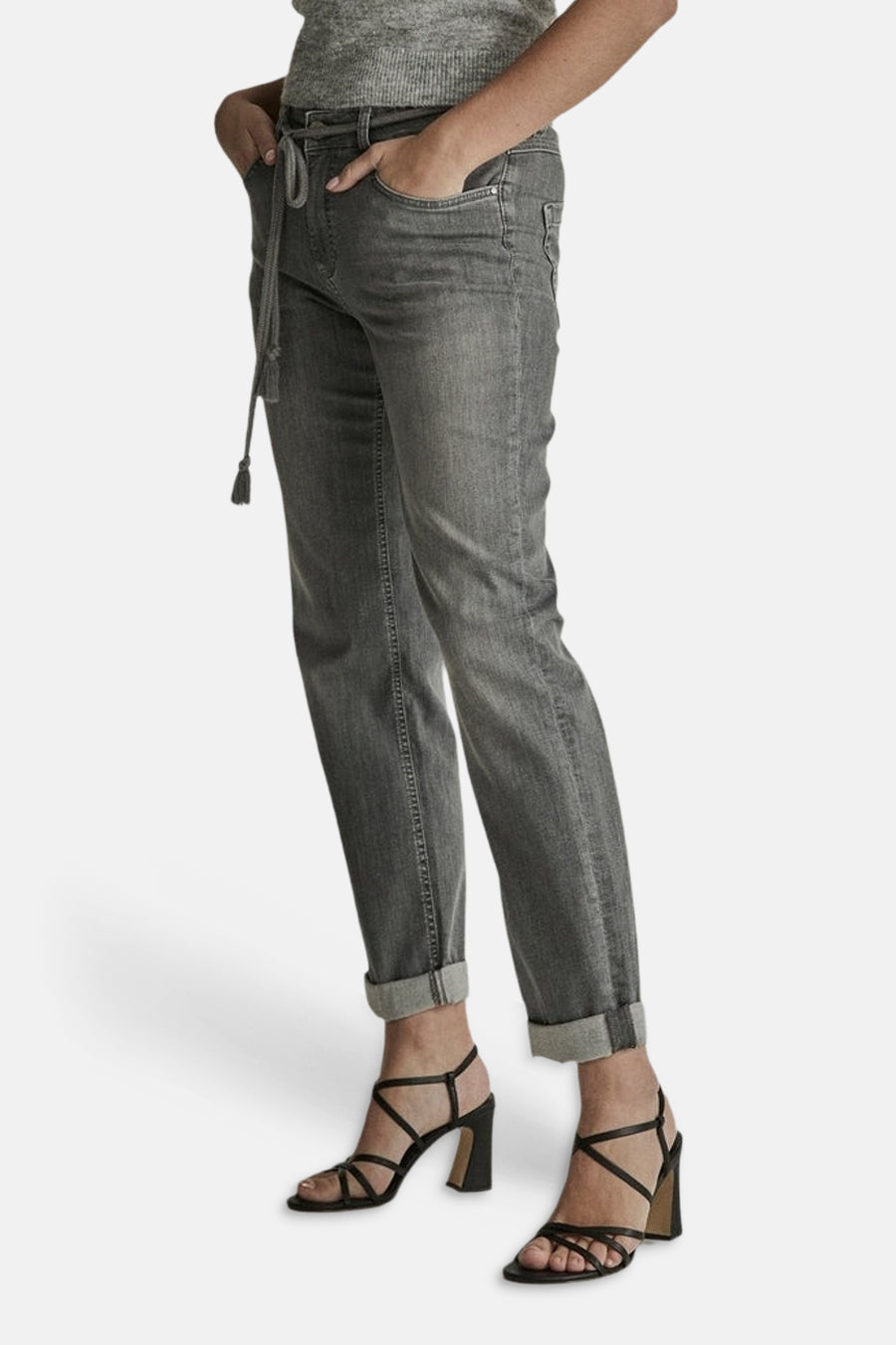 Light grey denim jeans by BOBBY, side view with rolled cuffs and drawstring waist, worn with black strappy heels