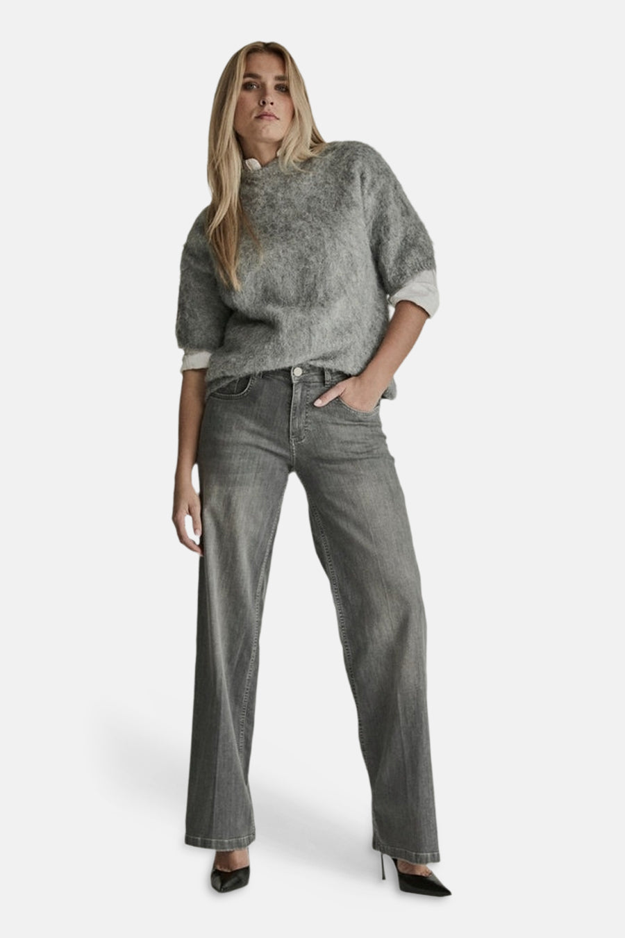 Light grey wide-leg denim jeans by MIRA, featuring a high waist and relaxed fit, worn with a textured grey sweater and black heels in a full-length front view.