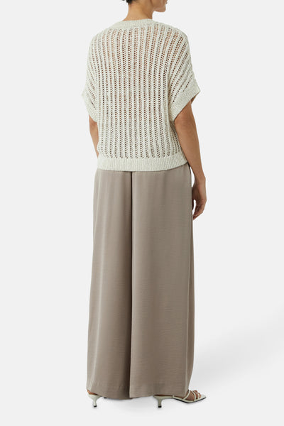 Pull à col rond beige de COMMA, avec motif ajouré sur le haut et pantalon fluide taupe.
