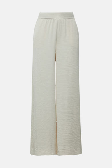Pantalon écru de COMMA, coupe ample à jambes larges et taille élastiquée.
