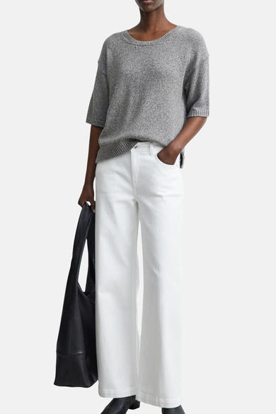 Brown crewneck sweater by COMMA, textured knit with ribbed hem and cuffs, worn with white wide-leg pants and black tote bag, front view.