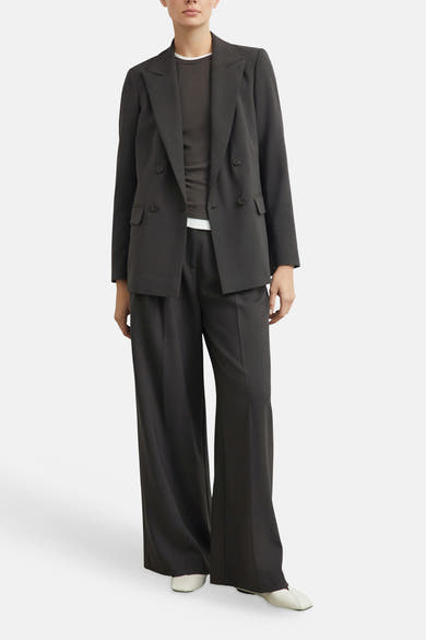 Brown wide-leg suit trousers by COMMA, worn with matching blazer, layered over dark top and white shoes, full-length front view