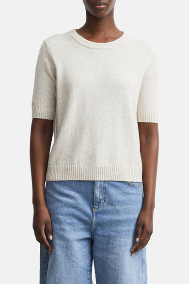 Beige ribbed knit short-sleeve crewneck sweater by COMMA, shown on model with light blue jeans, front view