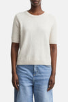 Beige ribbed knit short-sleeve crewneck sweater by COMMA, shown on model with light blue jeans, front view