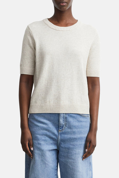 Beige ribbed knit short-sleeve crewneck sweater by COMMA, shown on model with light blue jeans, front view