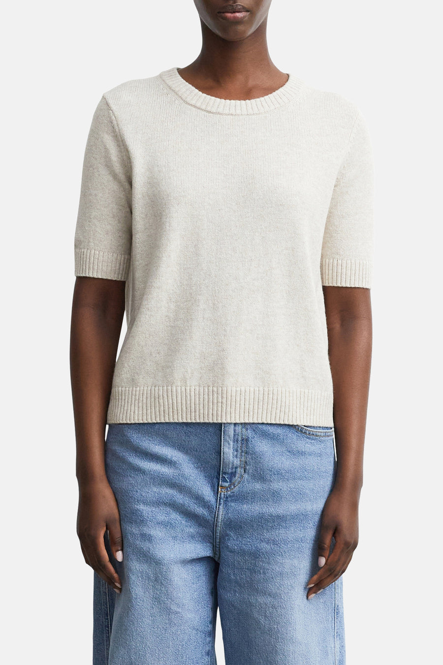 Beige ribbed knit short-sleeve crewneck sweater by COMMA, shown on model with light blue jeans, front view