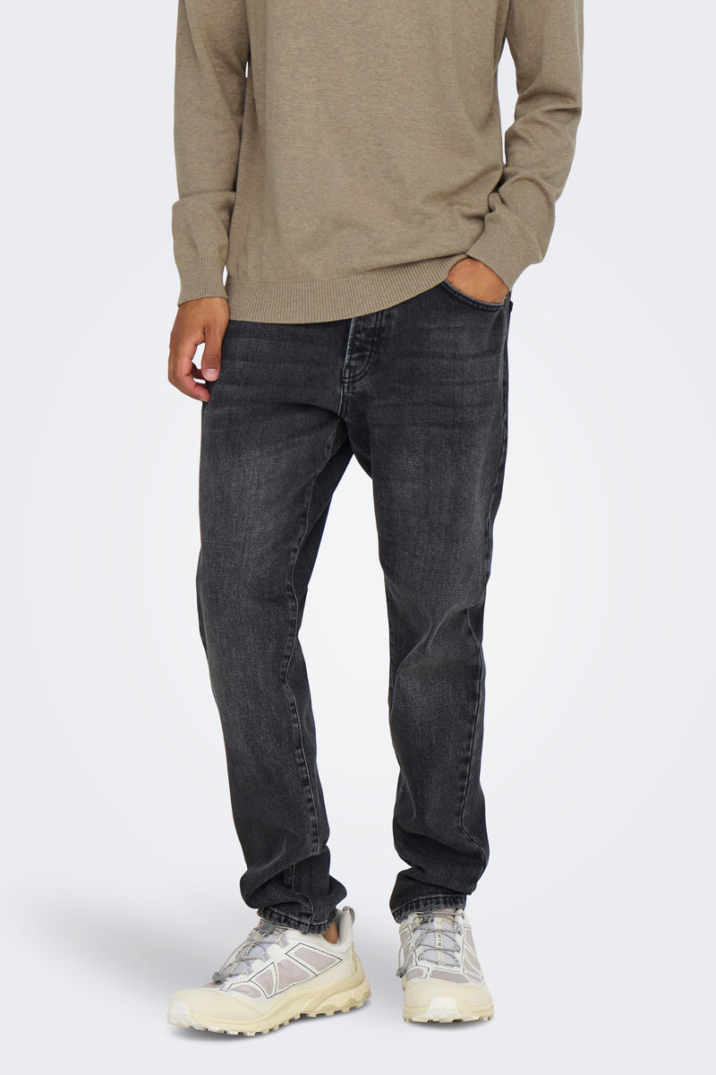 Middelgrijze tapered jeans van ONLY & SONS®, gedragen met een beige trui en trendy sneakers.