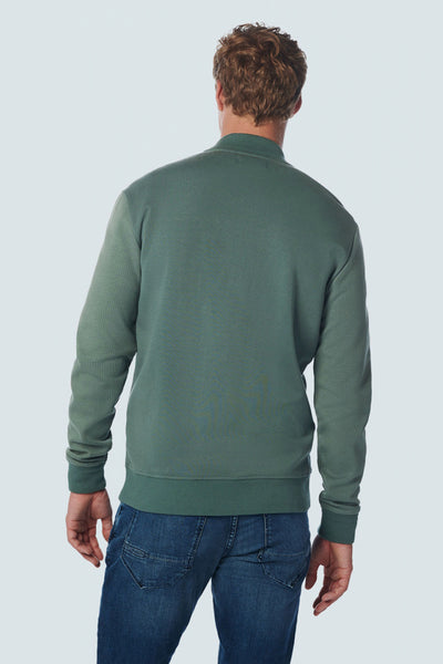 Green textured sweatshirt gilet back view with ribbed cuffs and waistband, worn with blue jeans