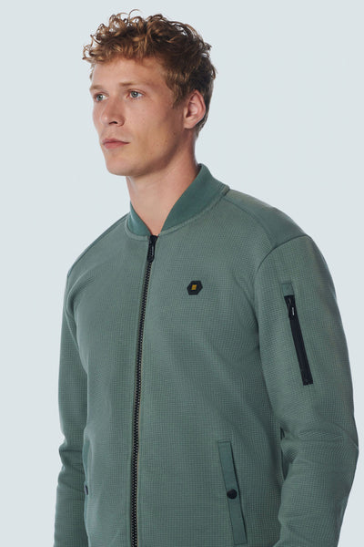 Green textured zip-front sweat gilet with black zipper and sleeve pocket, side view on model