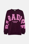 Dark purple crewneck sweatshirt with bold pink "BABY IS WHEREVER YOU ARE" graphic, by Toga Pulla, front view