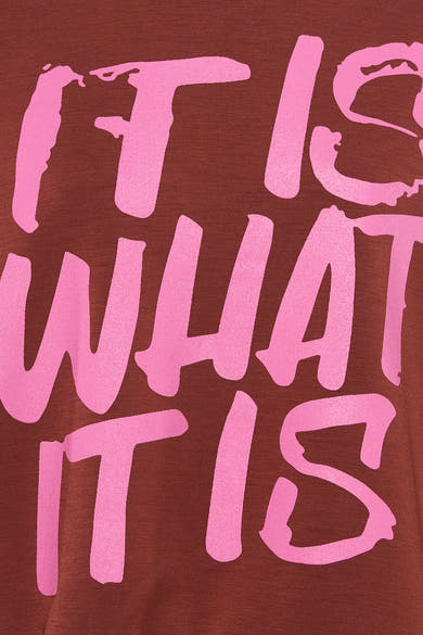 Multicolored crewneck sweatshirt with bold pink graffiti-style text "IT IS WHAT IT IS" on deep red fabric, close-up front view