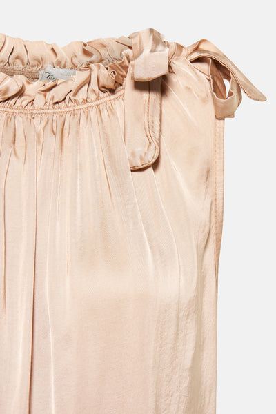 Top sans manches beige de Terra di Siena avec des détails froncés et un nœud décoratif.
