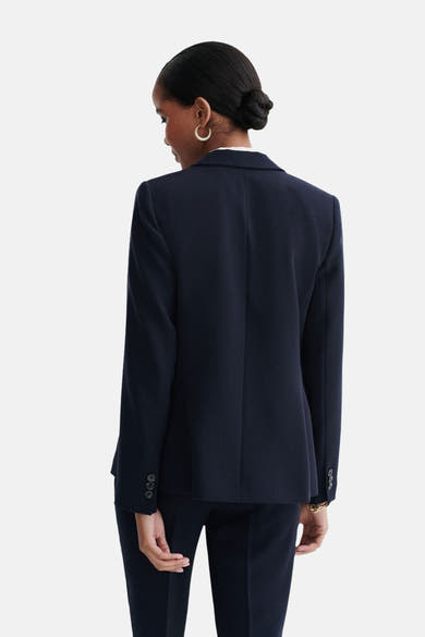 Blazer bleu marine de CAROLL, avec revers, boutons aux poignets et coupe ajustée.