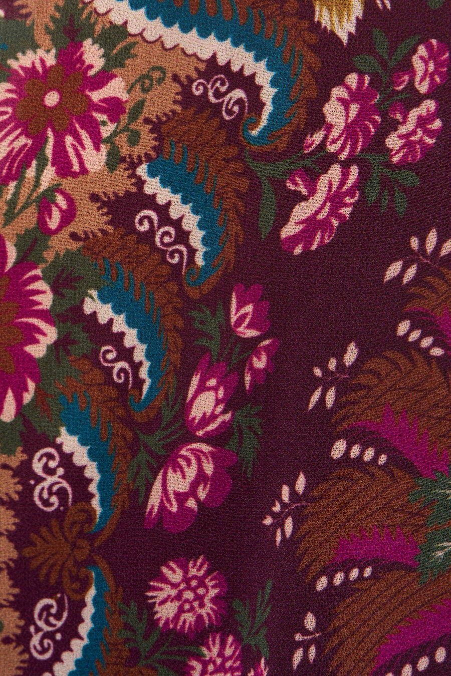 Multicolored sleeveless robe with vibrant floral and paisley pattern, rich textured fabric close-up