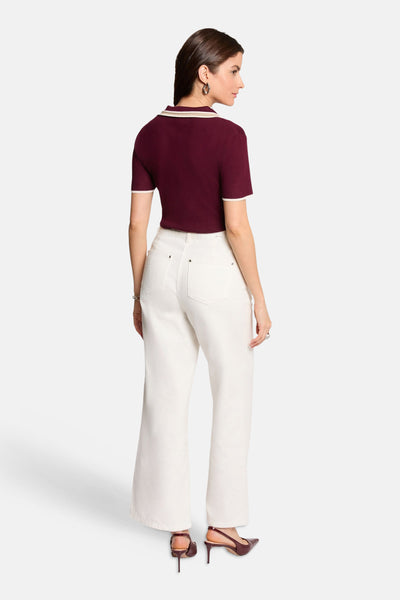 Bordeaux short-sleeve cardigan with cream trim, back view, paired with white wide-leg pants and burgundy heels