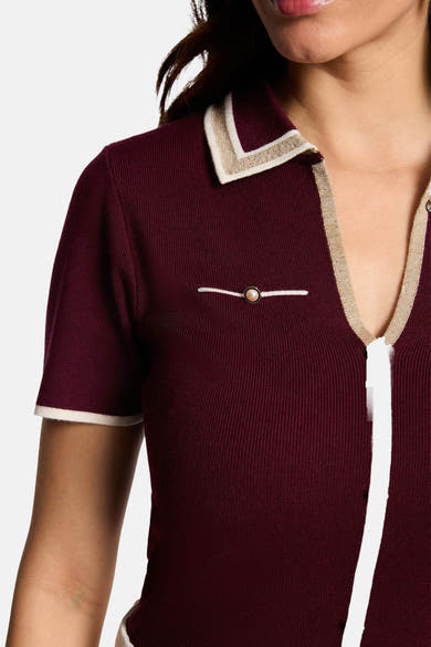 Bordeaux ribbed cardigan with cream and gold trim collar, pearl button detail, short sleeves, front view