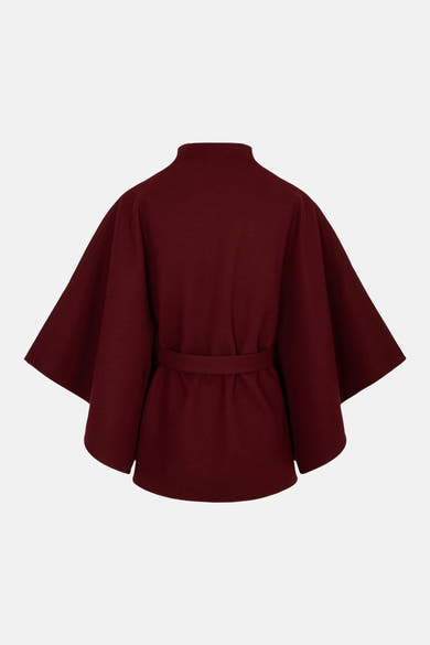 Burgundy wool poncho with high neck and belted waist, back view, solid color, structured silhouette