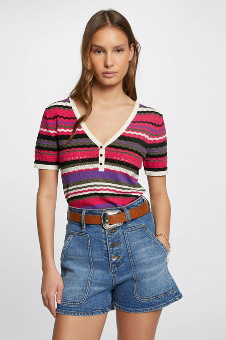 Multicolored short-sleeve V-neck sweater with wavy striped pattern, cream trim, and front buttons, worn with denim shorts and brown belt in lifestyle front view