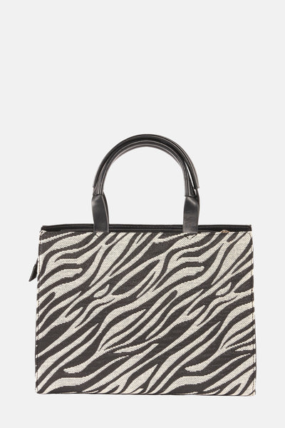 Sac à main en motif zèbre de Morgan de Toi, avec anses courtes noires et fermeture zippée.

