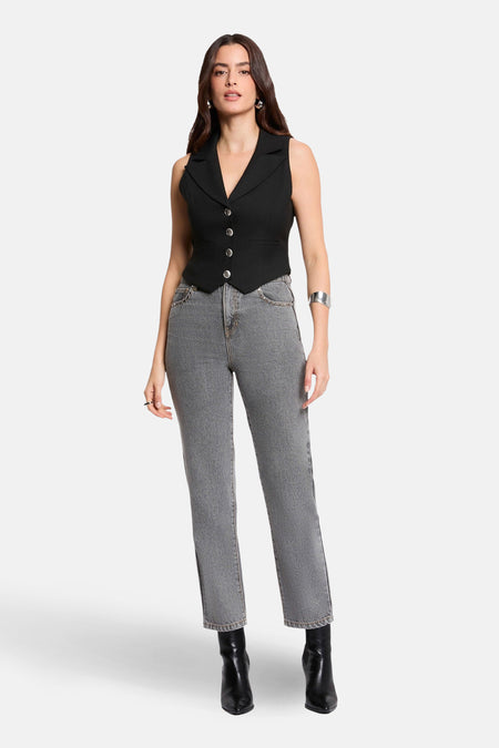 Zwarte mouwloze blazer van Morgan de Toi met zilveren knopen, gedragen met een grijze jeans.