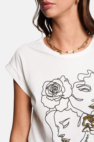 T-shirt blanc à manches courtes de Morgan de Toi avec imprimé graphique de visages et fleurs.