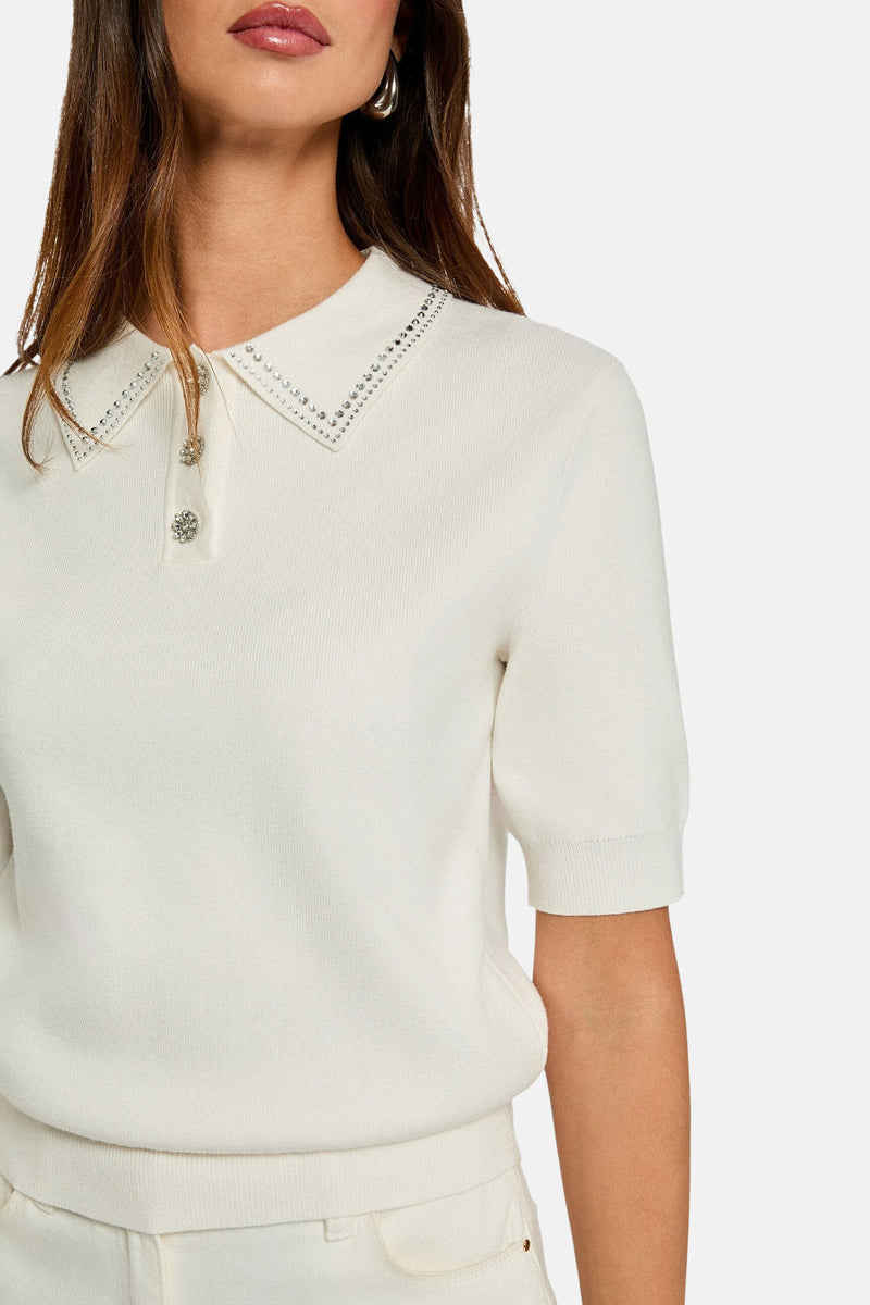 Wit poloshirt van Morgan de Toi, versierd met decoratieve strassteentjes en glanzende knopen.