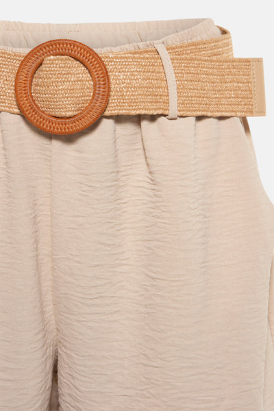 Short beige texturé de Terra di Siena, avec une ceinture de paille à boucle ronde marron.