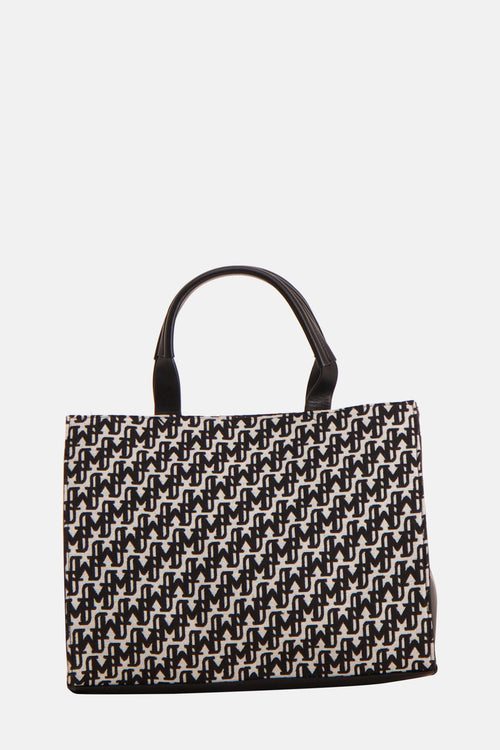 Sac à main multicolore de Morgan de Toi avec un motif graphique noir et blanc et anses noires.
