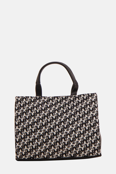 Sac à main multicolore de Morgan de Toi avec un motif graphique noir et blanc et anses noires.
