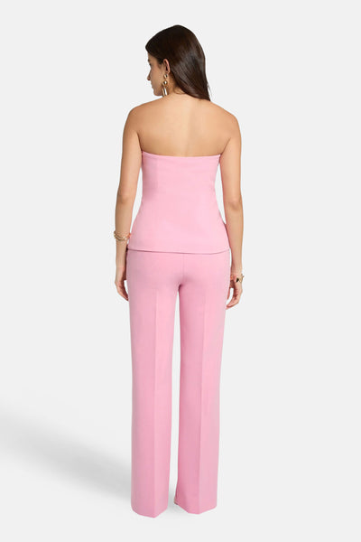 Roze Morgan de Toi bustier met peplumtaille, van achteren gezien, gedragen met een bijpassende broek.