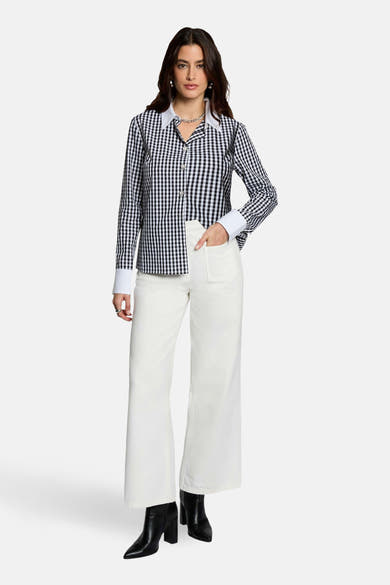 Chemise à manches longues noire à carreaux, de Morgan de Toi, avec col et poignets blancs.